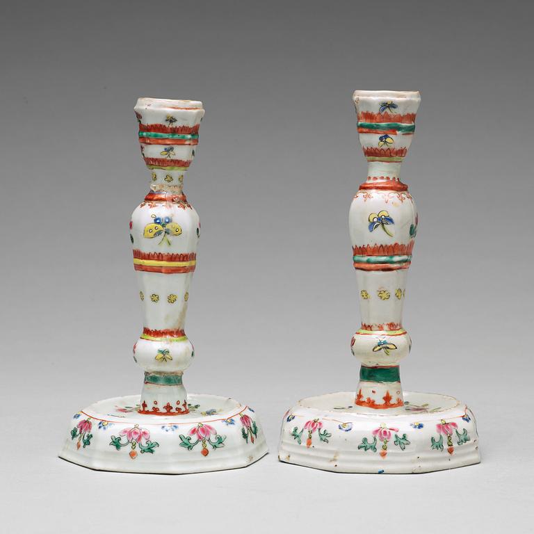 A pair of famille rose candle sticks, Qing dynasty, Qianlong (1736-95).