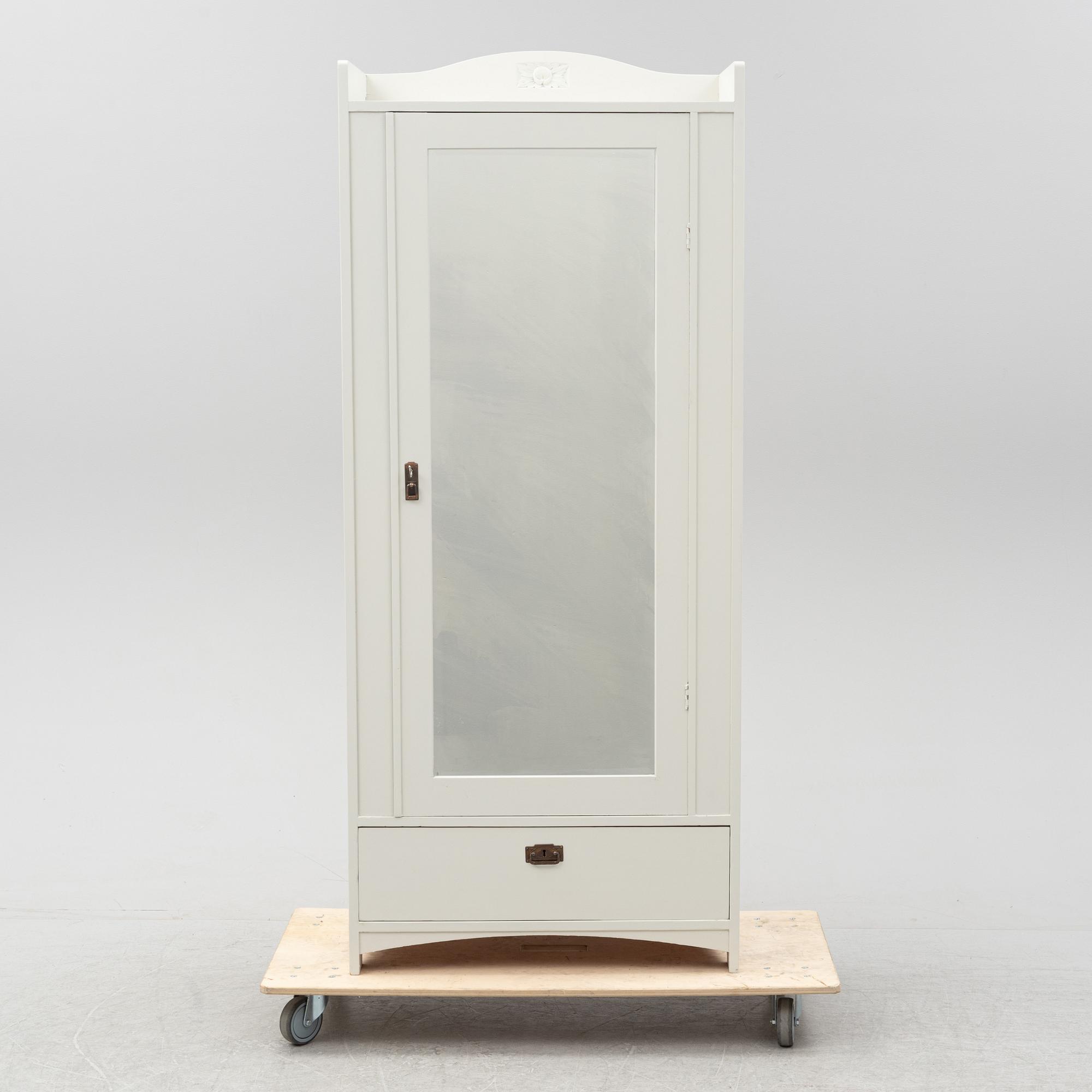 An early 20th Century painted clothes cabinet.