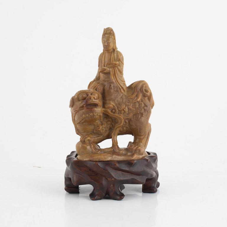 A soapstone guanyin with wooden stand, China, late Qing dynasty/early 20th century.