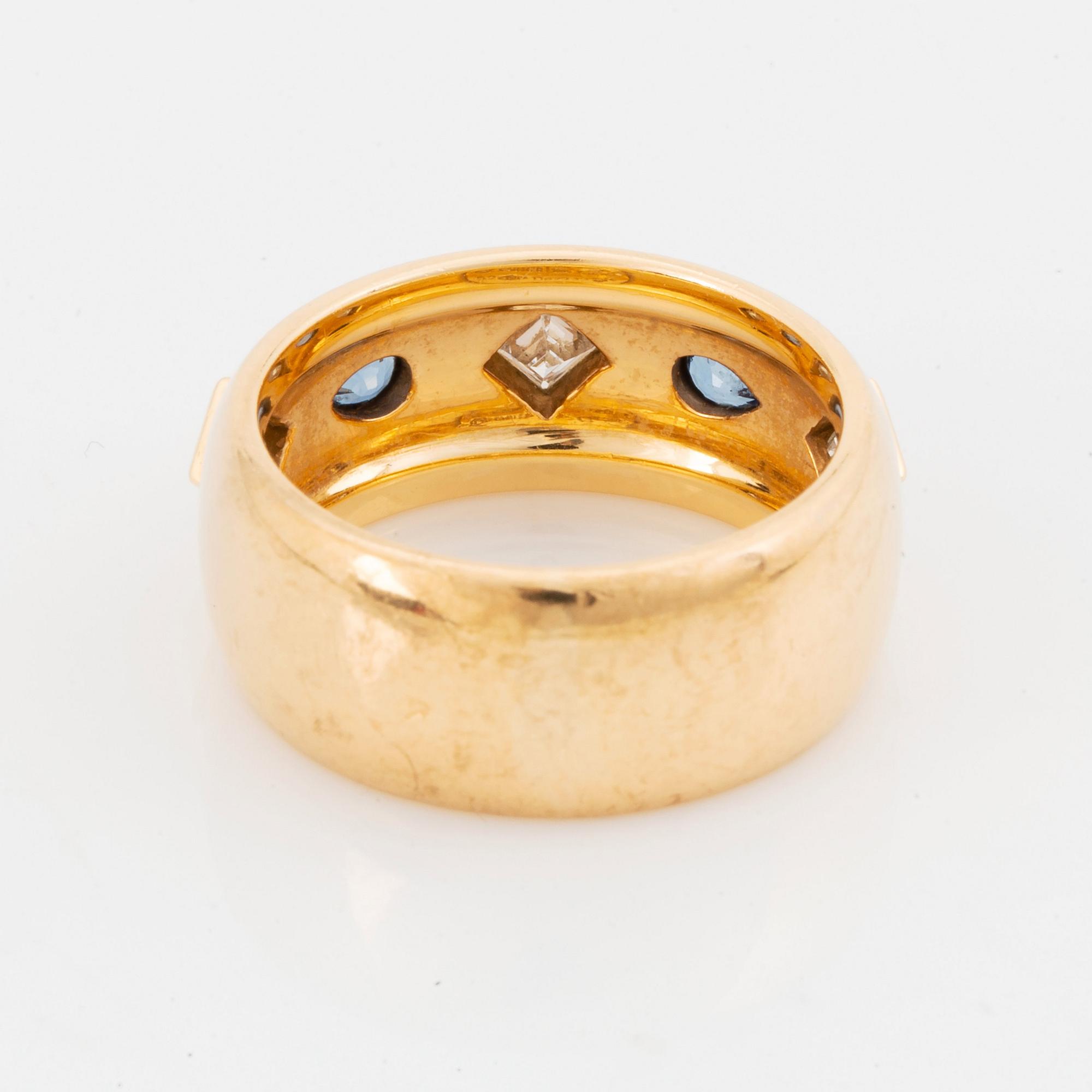 An 18K gold Cartier ring set with step-cut diamonds and faceted sapphires.
