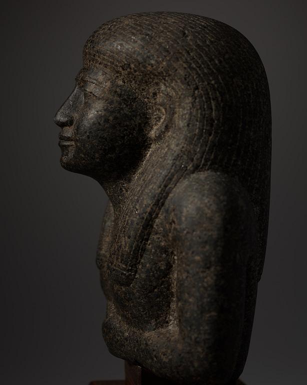 An Egyptian black granite bust of a man, 19th century or older.