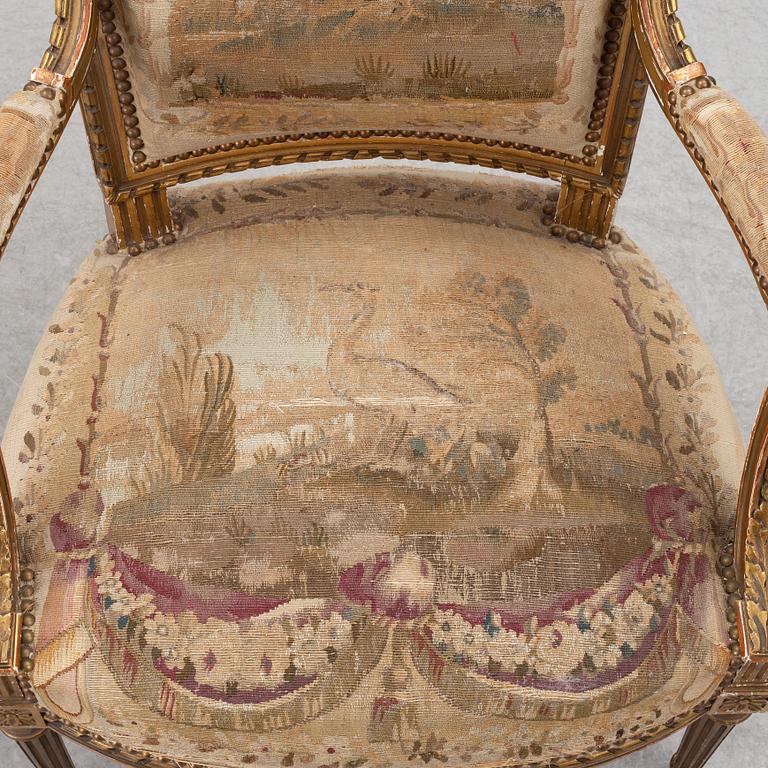 A pair of Louis XVI-style armchairs, late 19th century with 18th century fabric.