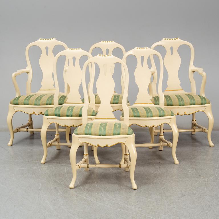 A rococo style dining table, four chairs and a pair of armchairs.