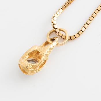 An 18K gold Lapponia pendant set with a round brilliant-cut diamond.