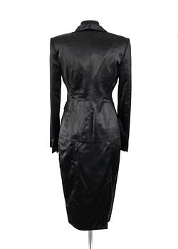 A two-piece black silk costume consisting of jacket and skirt by Gucci.