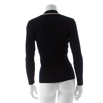 CÉLINE, a navy blue cardigan.