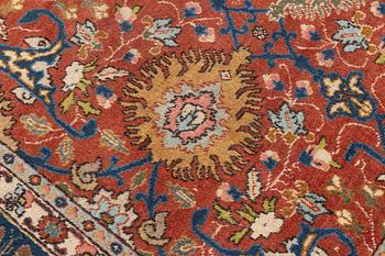 An antique/semi antique Tabriz carpet, c. 325 x 229 cm.