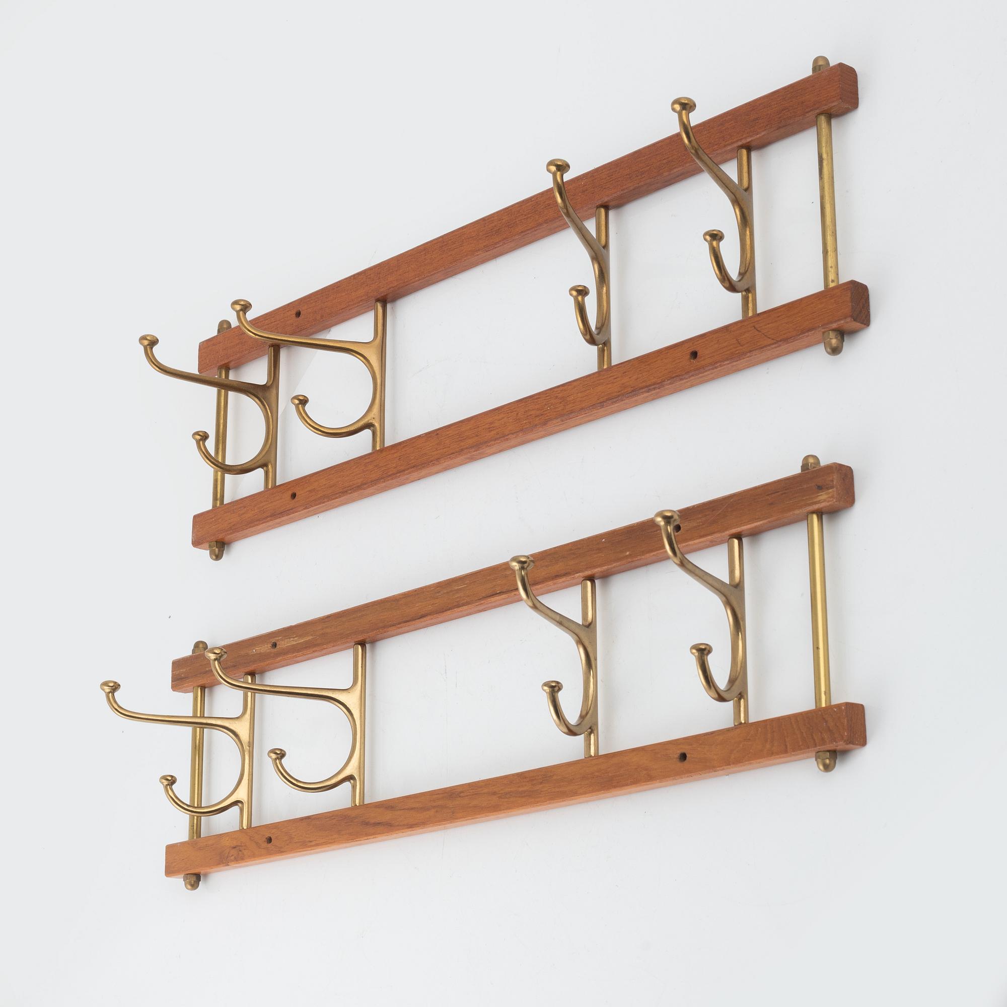 A pair of 'Dekorativ' coat hangers, Skoglunds metallgjuteri, Anderstorp, mid 20th Century.