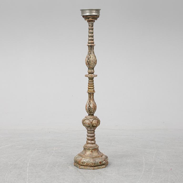 A wooden altar candlestick.