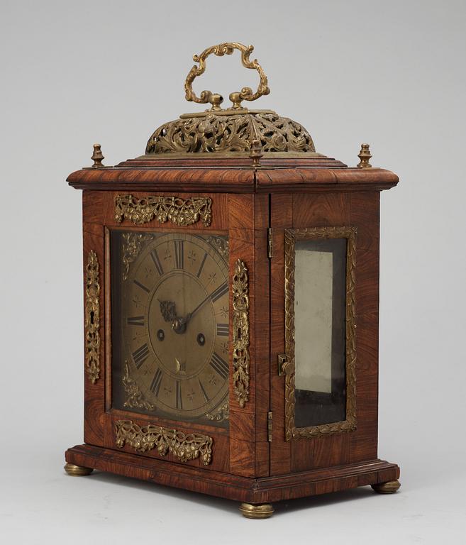 A Queen Anne early 18th century brass-mounted walnut striking table clock by Jacobeus Markwick.