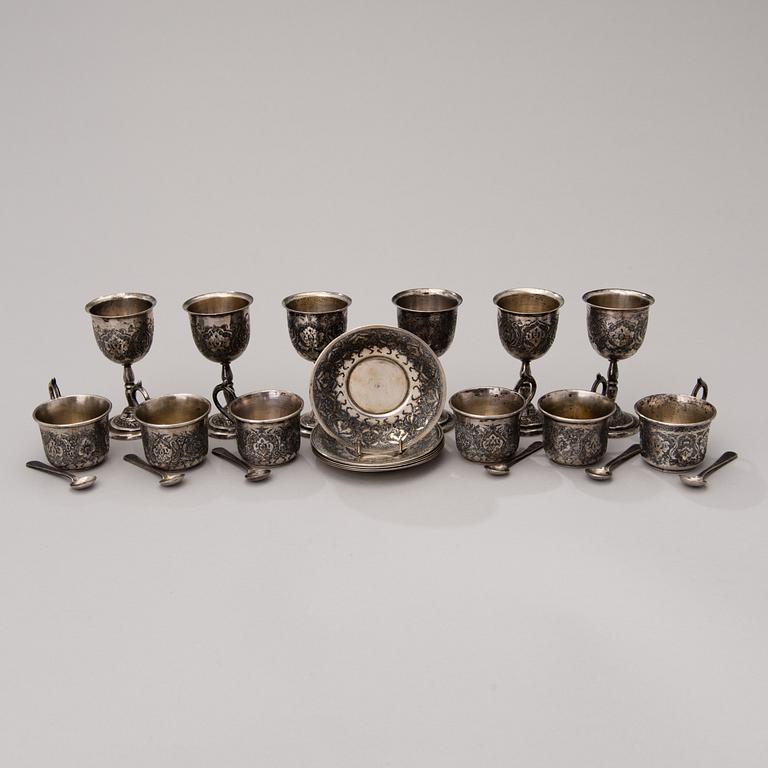 A set of six Persian silver coffee cups with spoons and saucers and six beakers, mid-20th century.