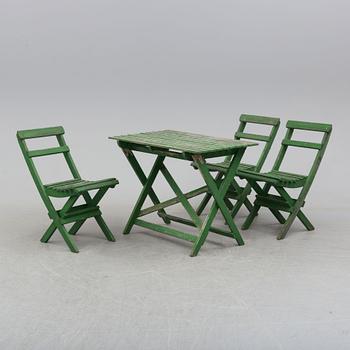 A garden table and three chairs.