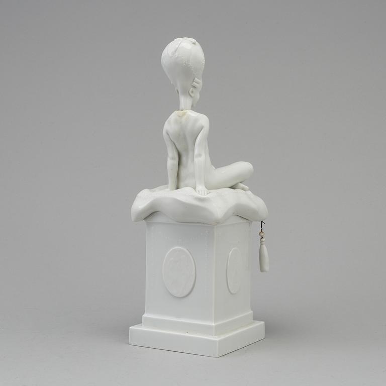 A white glazed Royal Copenhagen porcelain nodding head figure, Denmark, early 20th Century. Not first quality.