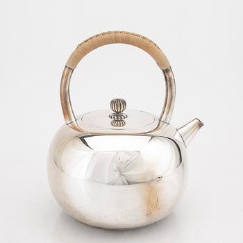 A Japanese early 20th century sterling silver tea pot.
