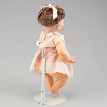 a porcelain doll from the early 20th century.
