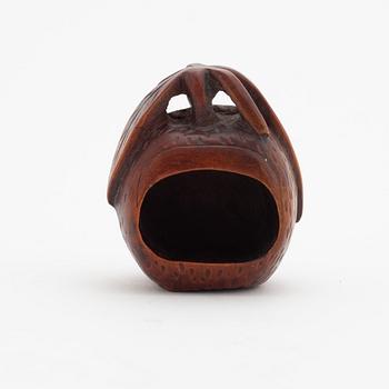 A Japanese carved corozo nut bird feeder, second half of the 19th Century.