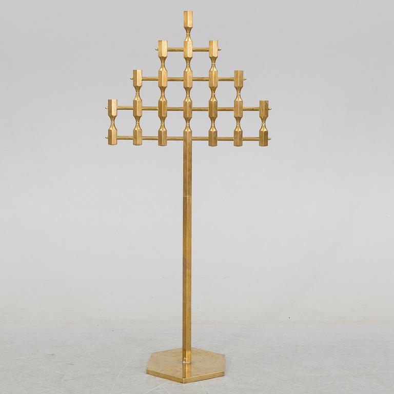 A brass floor candelabrum from Metallslöjden Gusum, signed BK and dated 1989.