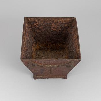 An early 19th century flower pot of cast iron.