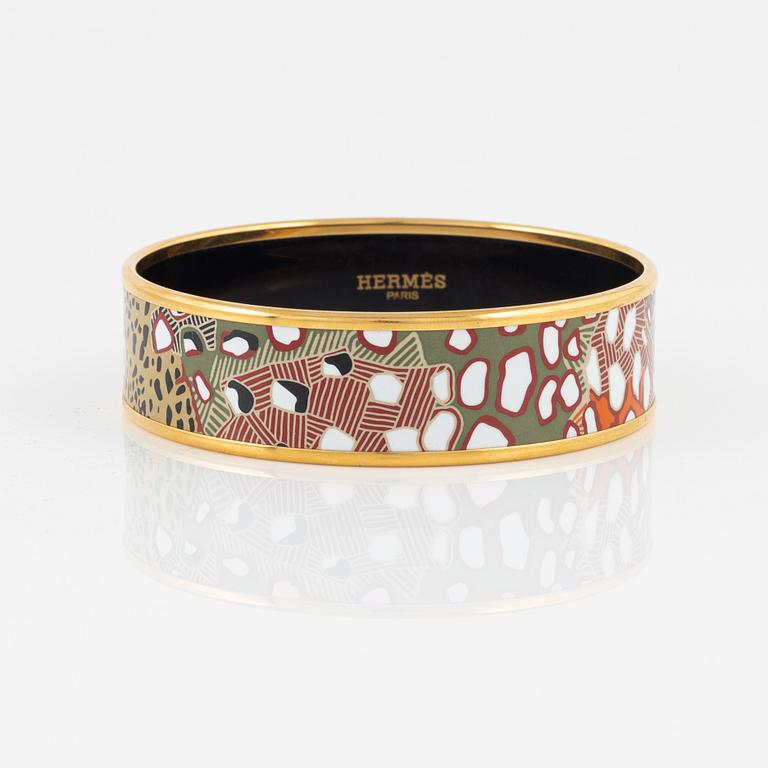 Hermès, an enamel and gold plated metal bangle.