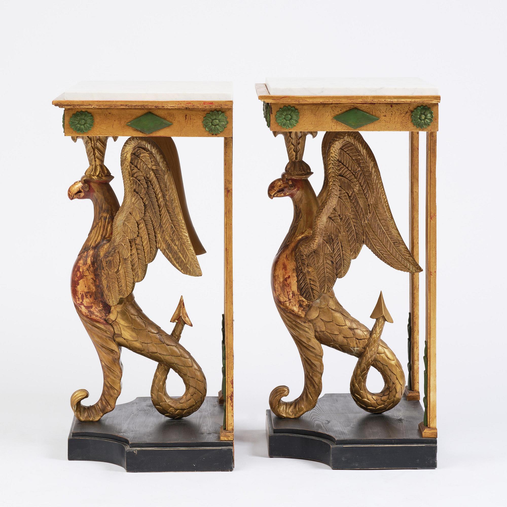 A pair of giltwood console tables, Empire-style incorporating older elements.