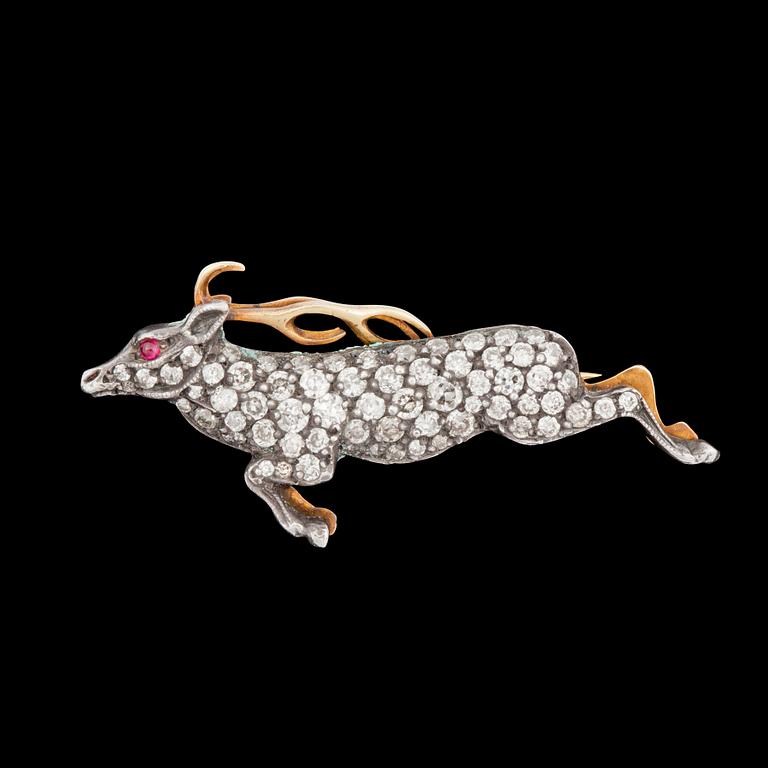 A old cut diamond, total carat weight circa 0.70 ct, and ruby brooch in the shape of a deer.