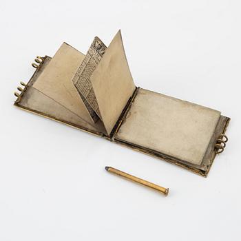 A gilt metal and mother-of-pearl pocket calendar, early 20th Century.