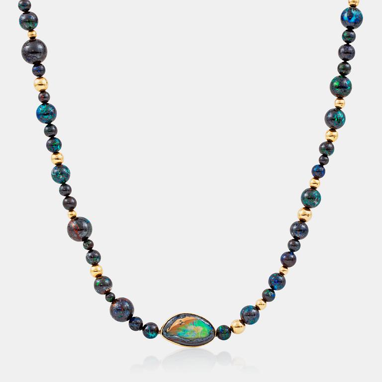 A necklace with beads of boulder opals, Ø 17.3-5.3 mm and gold beads. Made by Gaudi, Stoclkholm 1989.