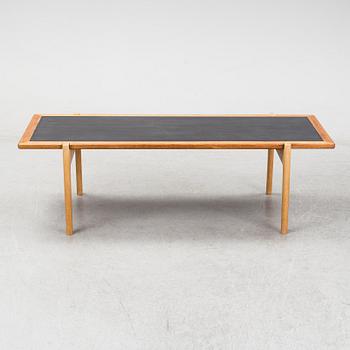 A model JH 575 coffee table by Hans J Wegner for Johannes Hansen.