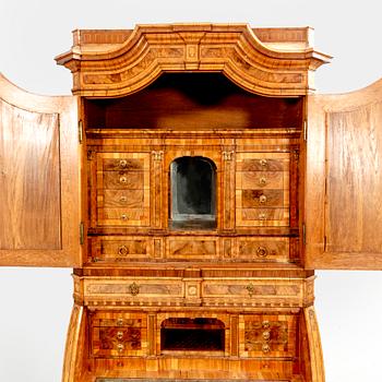 A German walnut and mahogany writing cabinet around 1800.