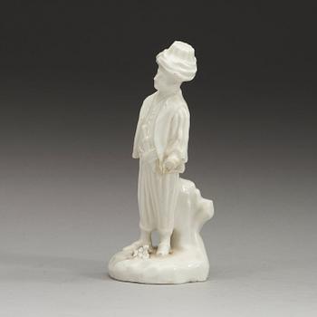 A Swedish Marieberg soft paste figure of a boy clad in Turkish garments, 18th Century.