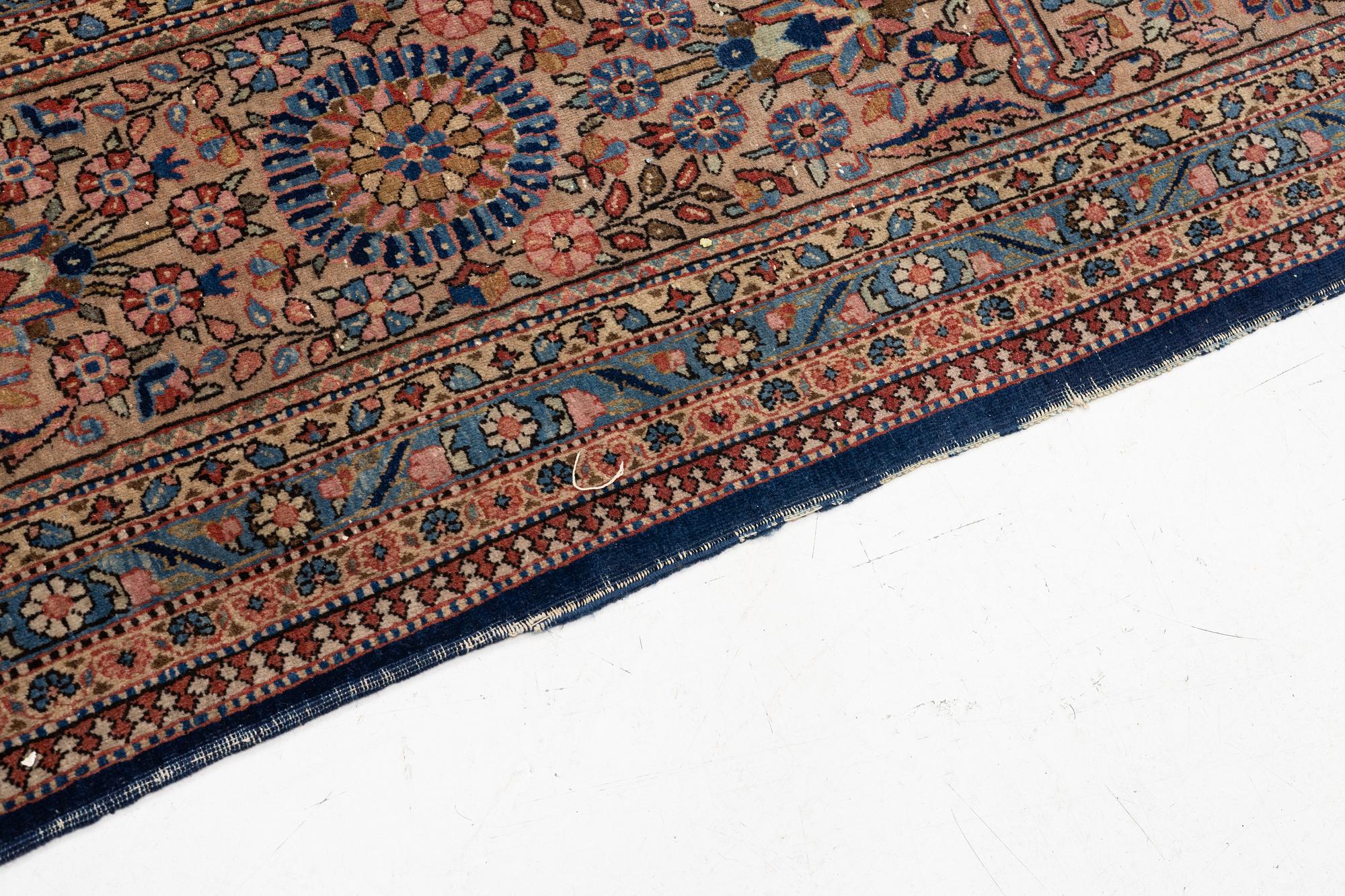 An oriental carpet, c. 425 x 305 cm.