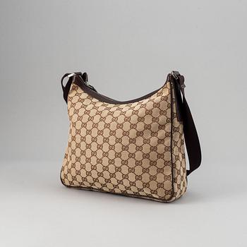 Gucci, a monogram canvas messenger bag.