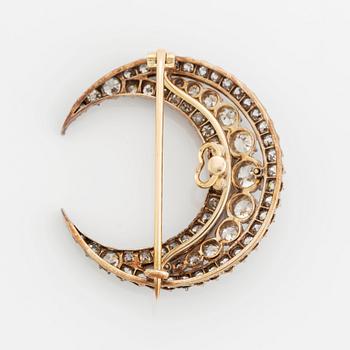 A crescent moon brooch in silver and gold set with old- and rose-cut diamonds.