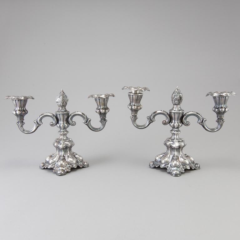 A pair of Swedish Rococo style silver candelabras from C G Hallberg in Stockholm 1955 and 1959.
