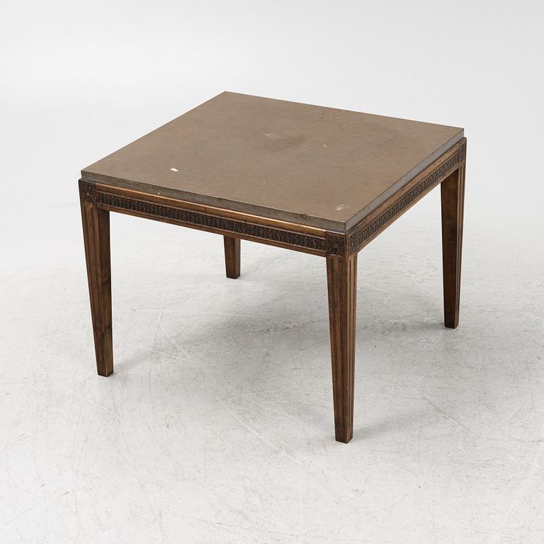 A Louis XVI style coffee table with a limestone top.
