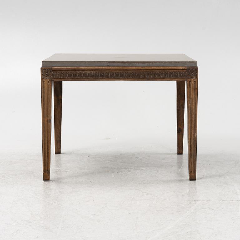 A Louis XVI style coffee table with a limestone top.