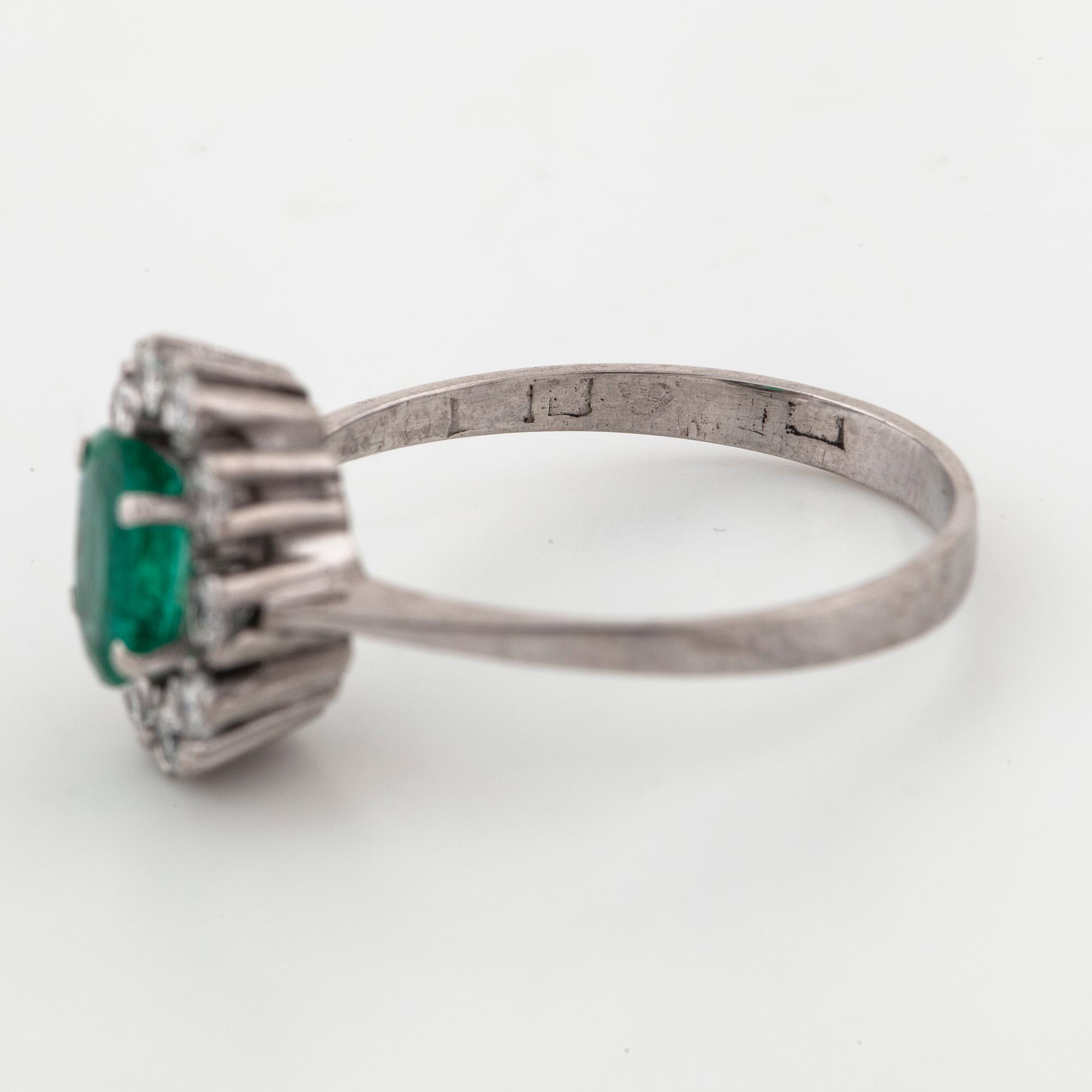 A emerald and brilliant cut diamond ring.