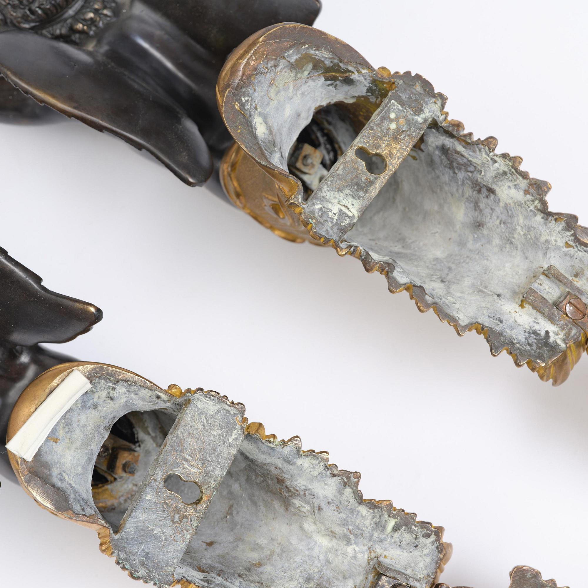 A pair of Napoleon III five-branch gilt and patinated bronze appliques.