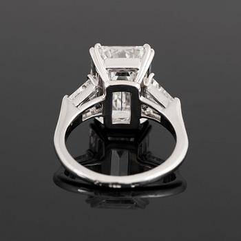 A platinum ring set with an emerald-cut diamond.