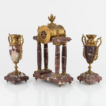 A Louis XVI-style Mantle Clock and a pair of decorative urns, early 20th Century.