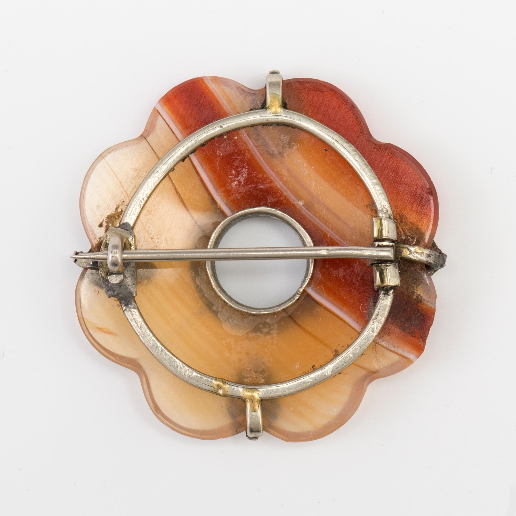 A BROOCH set with banded agate.