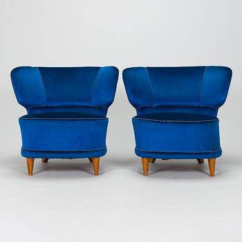 A pair of mid-20th-century armchairs.