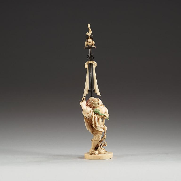 A Japanese Ivory okimono with inlays of mother of pearl and wood, Meiji period (1868-1912).