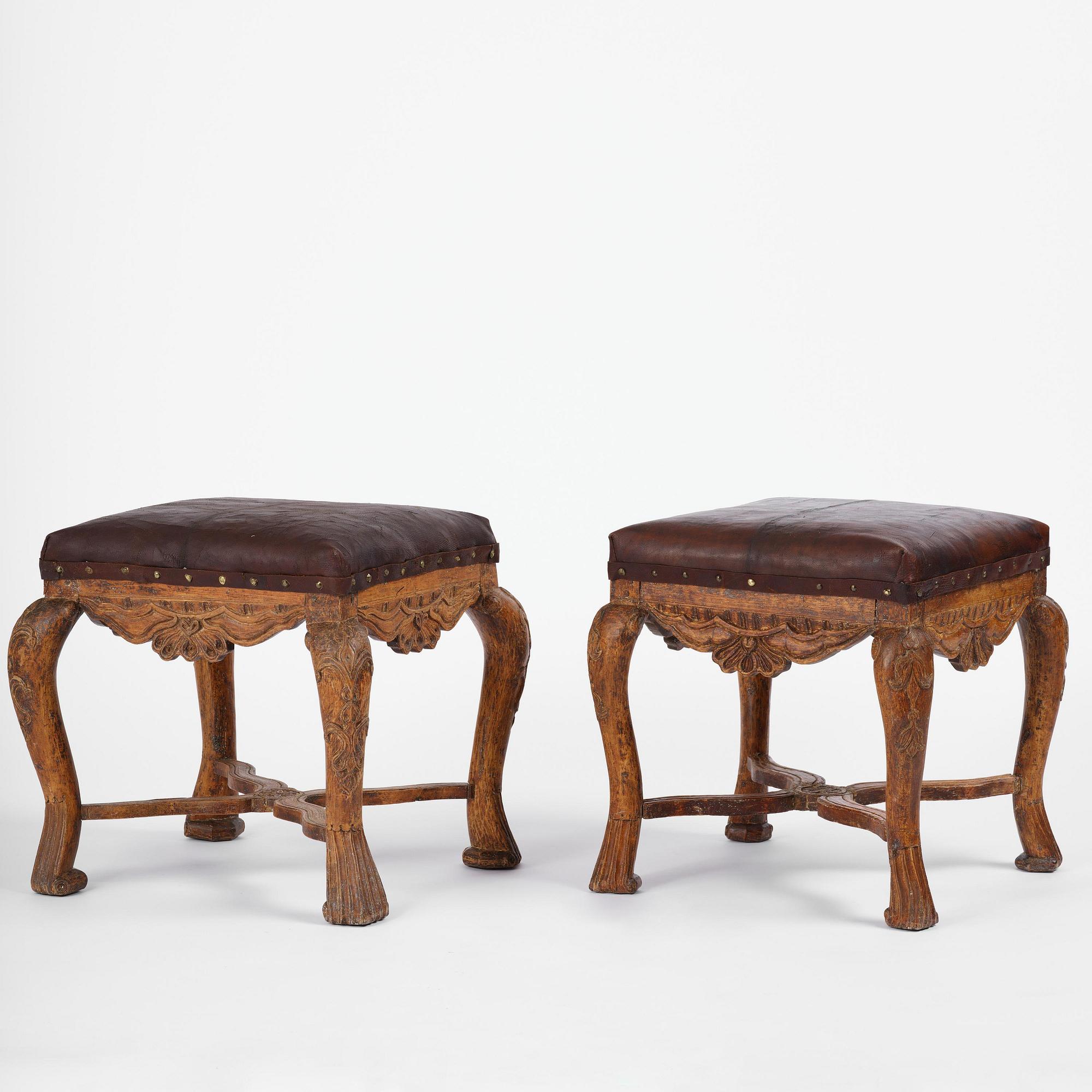 A pair of carved stools in the manner of Jonas Granberg, Jämtland, Sweden, mid 18th century.