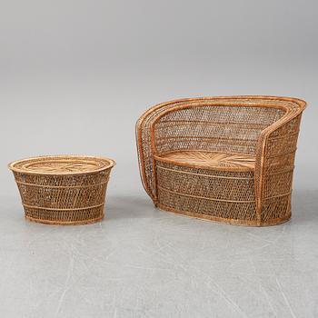 A late 20th Century rattan sofa with table.