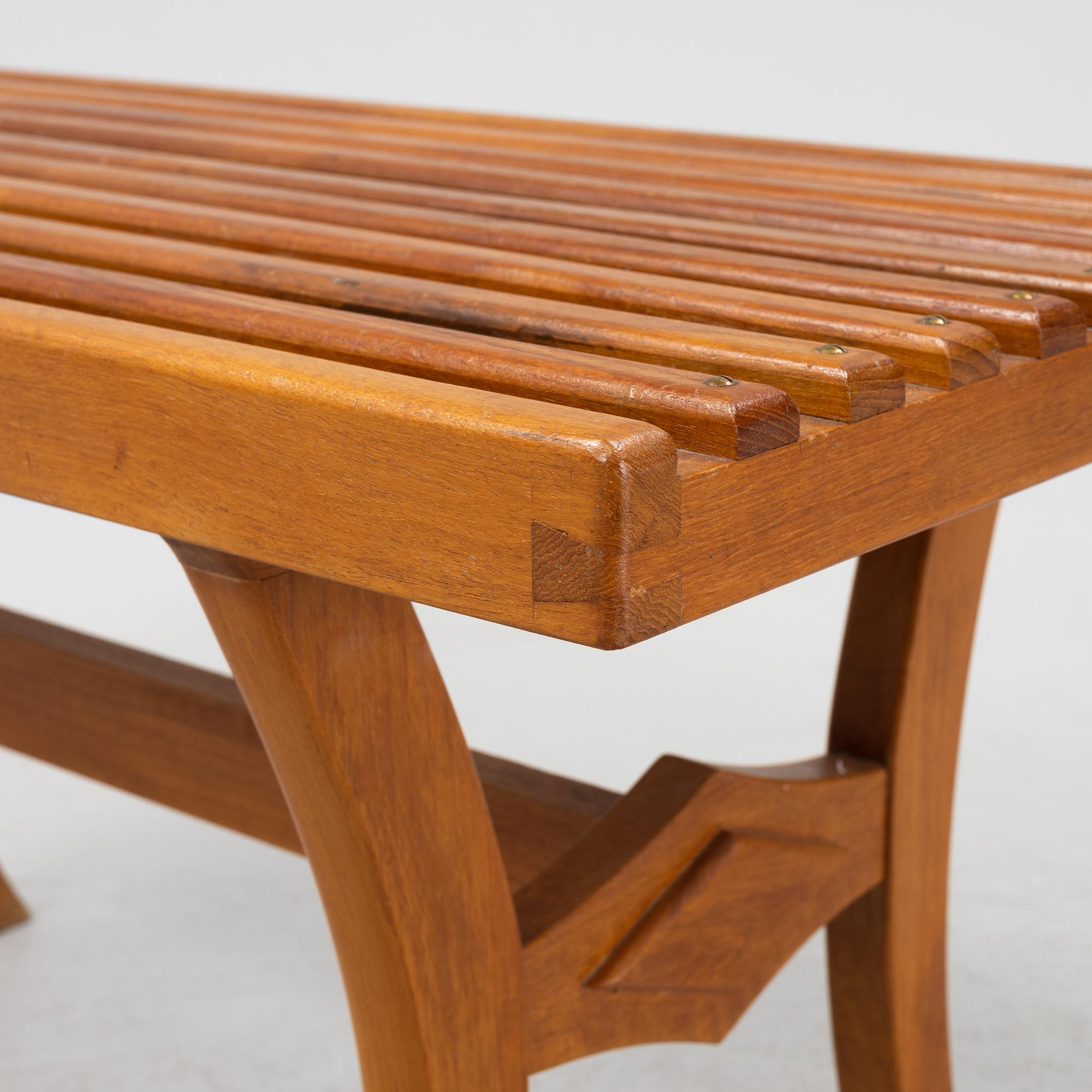A stained-wood bench, later part of the 20th Century.