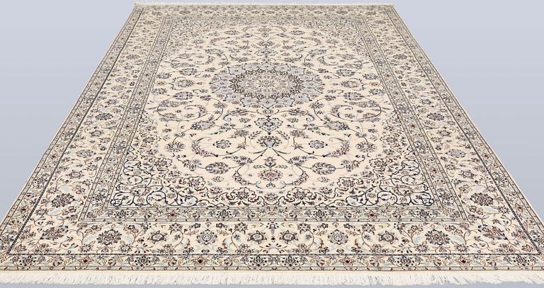 A Nain, part silk carpet, 305 x 207 cm.