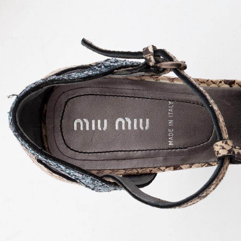MIU MIU, a pair of snake skin embossed leather and glitter sandals.