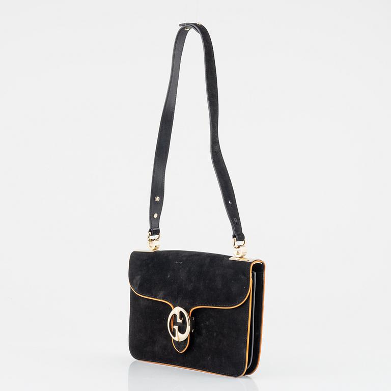 Gucci, a black suede and tan lining bag.