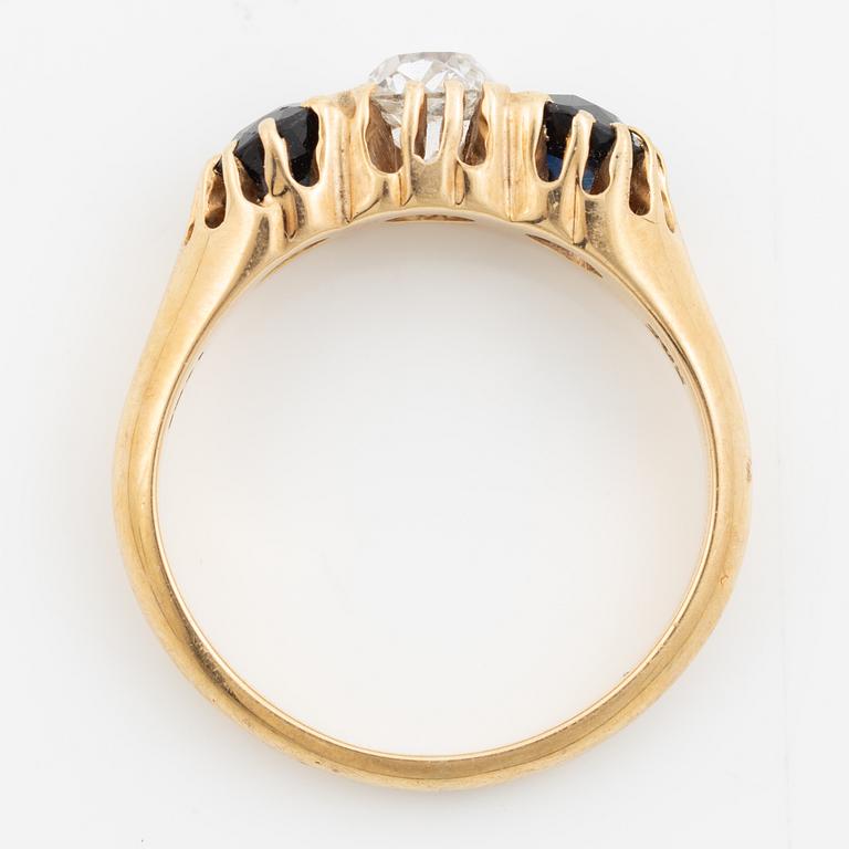 Ring 14K gold with an old-cut diamond and two blue stones.